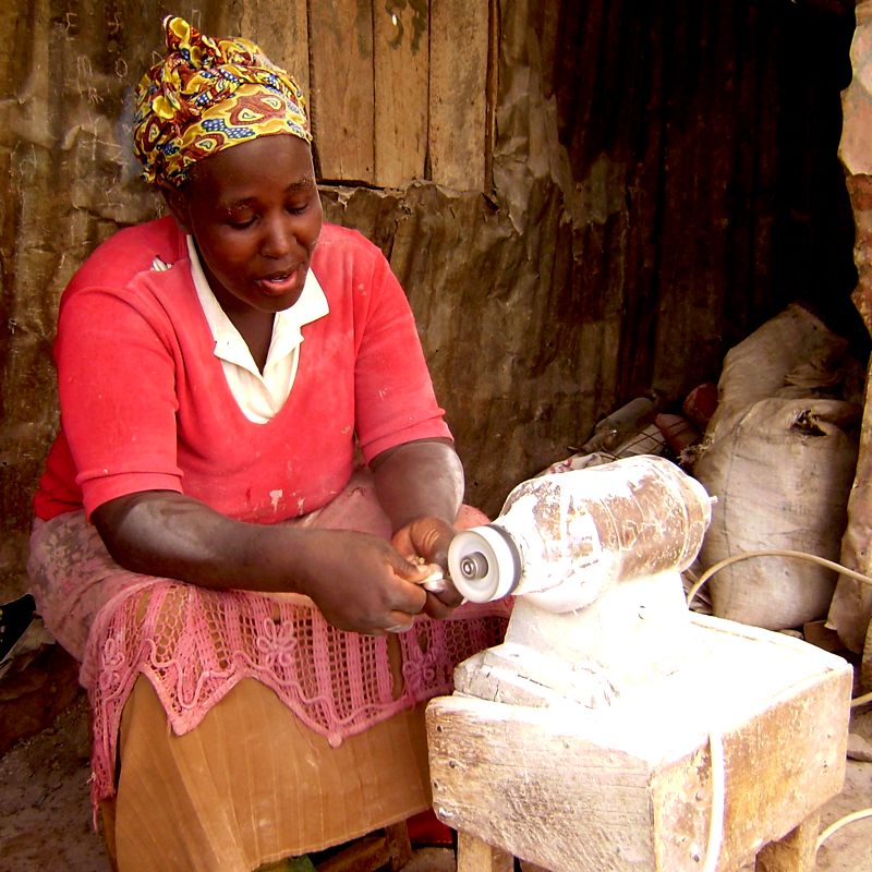 Shaping recycled bone beads Nairobi Kenya