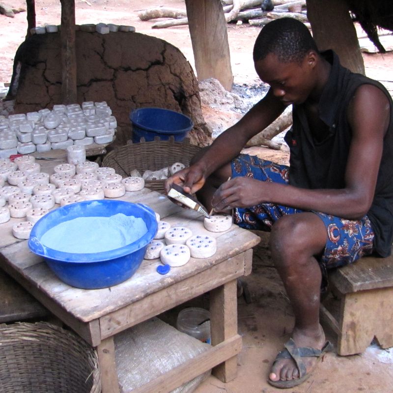 Filling bead mould with recyecled glass powder in Ghana