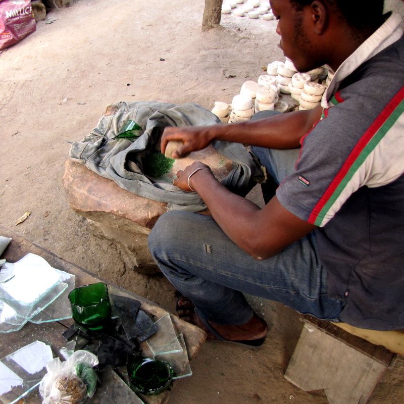 Crushing bottle glass for beads in Koforidua, Ghana