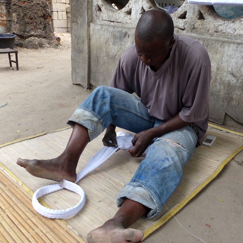 Musa Jaiteh tieing fabric in The Gambia